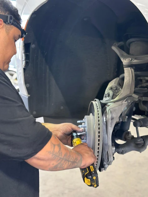 Our ASE-certified technician performing brake repair on vehicle