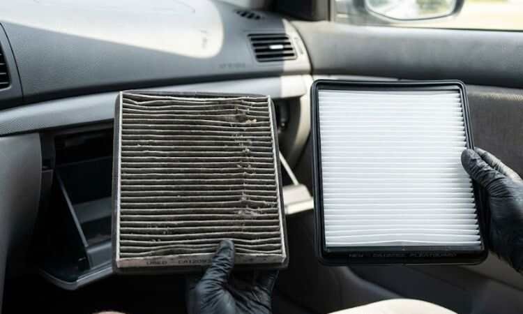 Heavily clogged dirty cabin air filter removed from car showing debris and reduced airflow