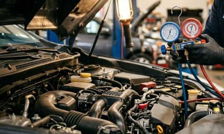 Auto technician examining car AC compressor and belt system during diagnostic inspection