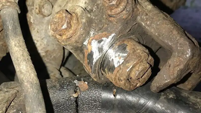 Rusted brake caliper piston showing corrosion and brake system wear